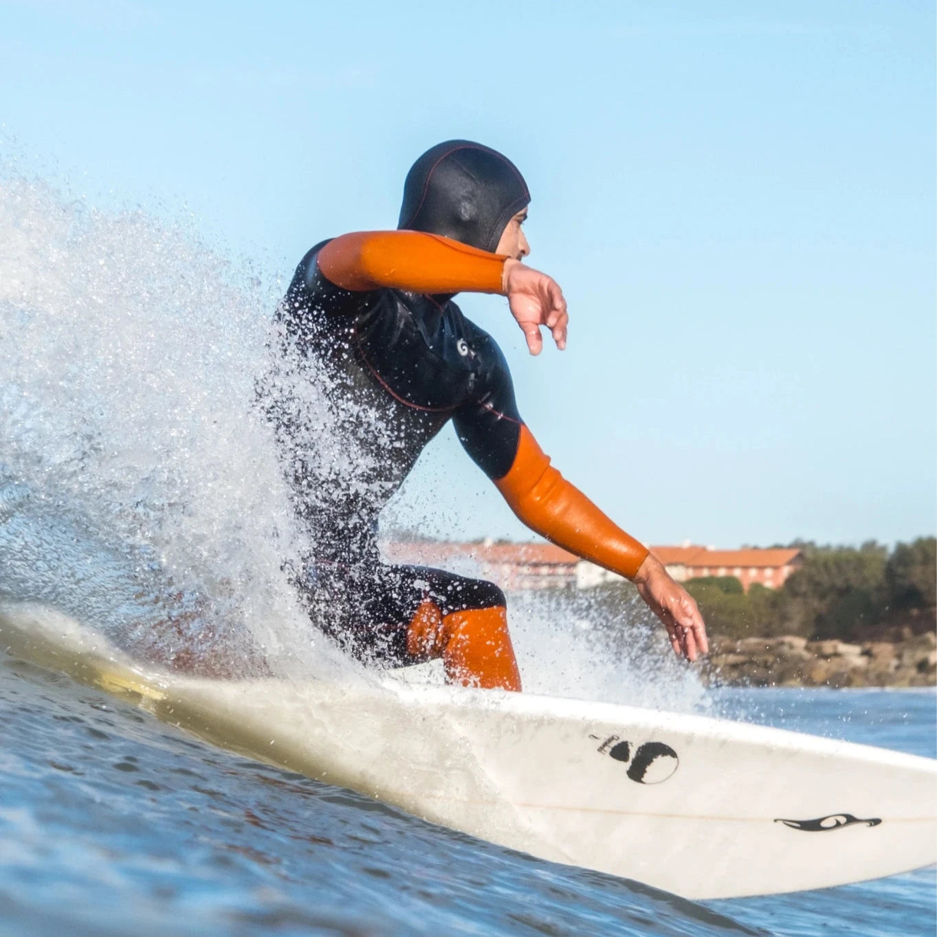 Men is Surfing with Full Hood Suit